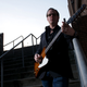 A photo of guitarist and singer Joe Bonamassa playing a Gibson Firebird guitar.